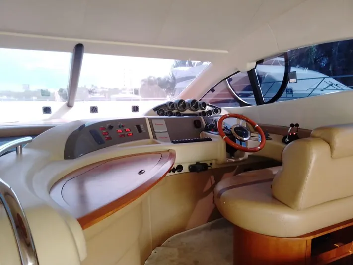  Yacht Photos Pics 2008 Azimut Flybridge yacht helm with leather seating and wooden accents.