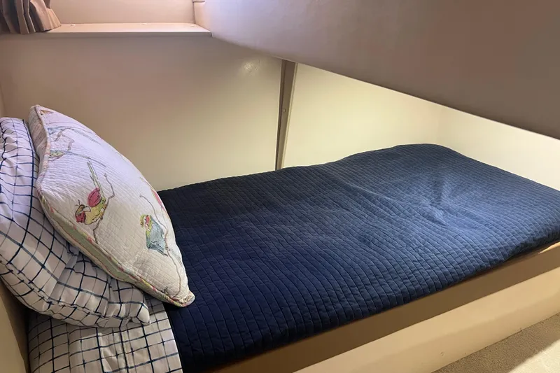 Ne Sea Yacht Photos Pics Cozy bunk bed in 2004 Carver 466 Motor Yacht with blue bedding and decorative pillow.