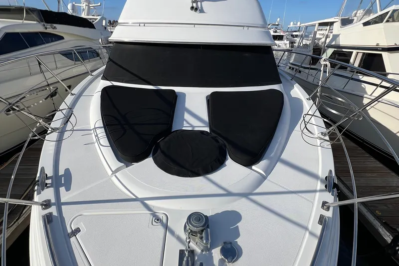 Ne Sea Yacht Photos Pics 2004 Carver 466 MY yacht deck with black sun pads, docked at marina.