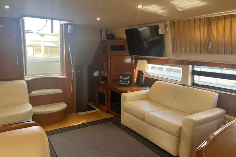 Ne Sea Yacht Photos Pics Luxurious interior of 2004 Carver 466 MY yacht with cream sofas and wood accents.