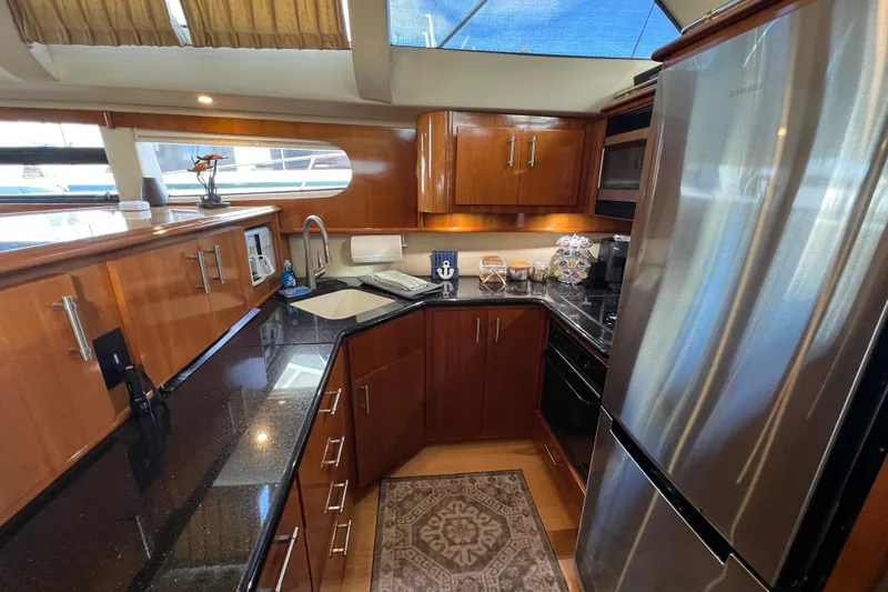 Ne Sea Yacht Photos Pics Luxurious kitchen interior of 2004 Carver 466 MY yacht with modern appliances and wood cabinetry.