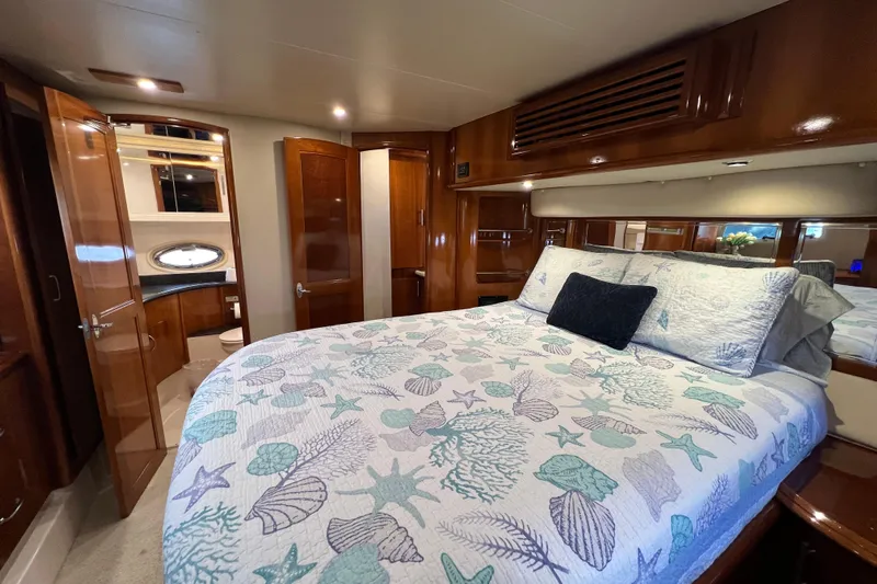 Ne Sea Yacht Photos Pics Luxurious 2004 Carver 466 MY yacht bedroom with elegant wood finishes and nautical-themed bedding.