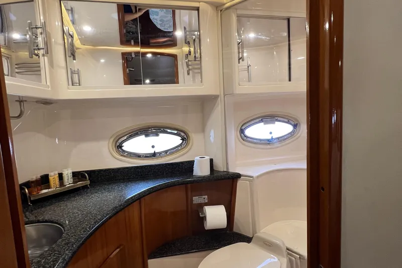 Ne Sea Yacht Photos Pics Luxurious bathroom interior of 2004 Carver 466 MY yacht with oval windows and sleek design.