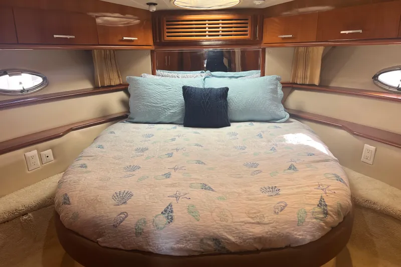 Ne Sea Yacht Photos Pics Luxurious 2004 Carver 466 MY yacht bedroom with elegant bedding and wood cabinetry.