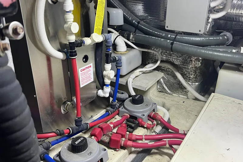 Ne Sea Yacht Photos Pics Engine room of 2004 Carver 466 Motor Yacht with plumbing and wiring systems.