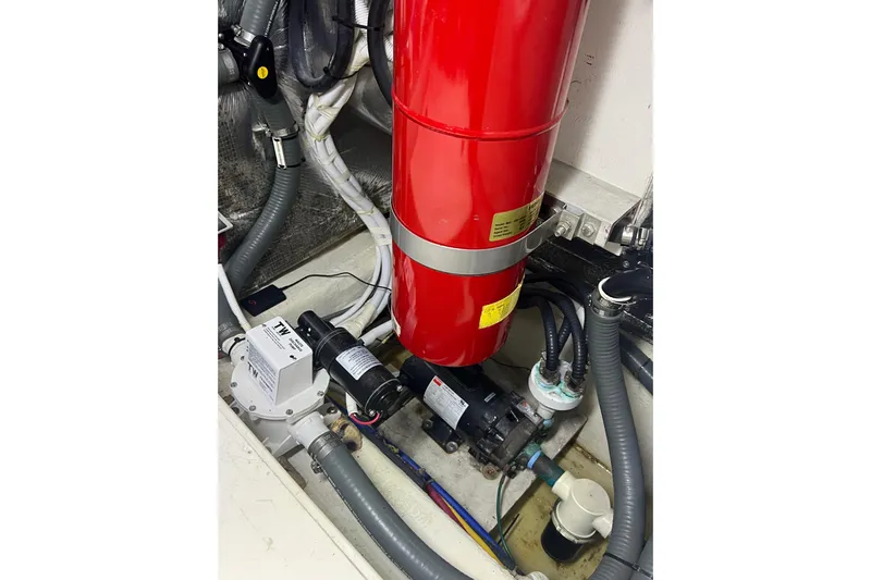 Ne Sea Yacht Photos Pics Engine room of 2004 Carver 466 MY with red fire extinguisher and mechanical components.