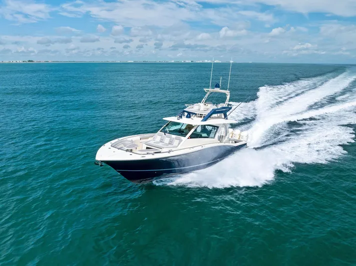 Bottom Line Yacht Photos Pics 2022 Scout LXF boat cruising on open blue ocean under clear skies.