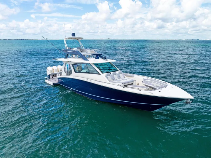 Bottom Line Yacht Photos Pics 2022 Scout LXF boat cruising on clear blue ocean waters.