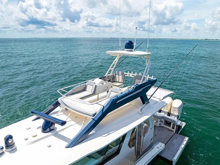 Bottom Line Yacht Photos Pics 2022 Scout LXF boat on open water, featuring sleek design and spacious deck.