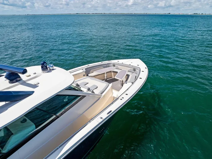 Bottom Line Yacht Photos Pics 2022 Scout LXF boat on clear blue water, showcasing sleek design and spacious deck.