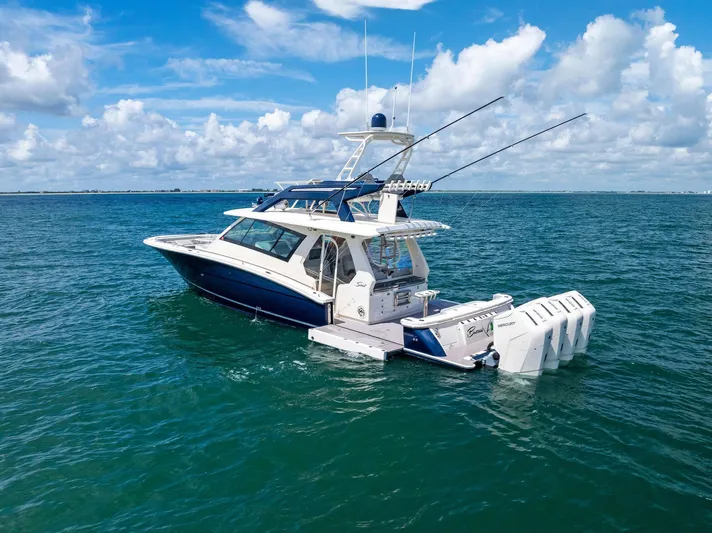 Bottom Line Yacht Photos Pics 2022 Scout LXF boat on open water under blue sky.