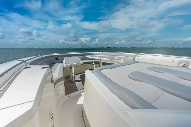 Bottom Line Yacht Photos Pics 2022 Scout LXF boat deck with seating, ocean view, and blue sky.