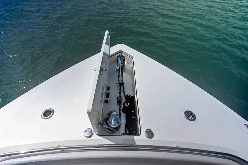 Bottom Line Yacht Photos Pics 2022 Scout LXF boat bow with anchor compartment, floating on clear water.