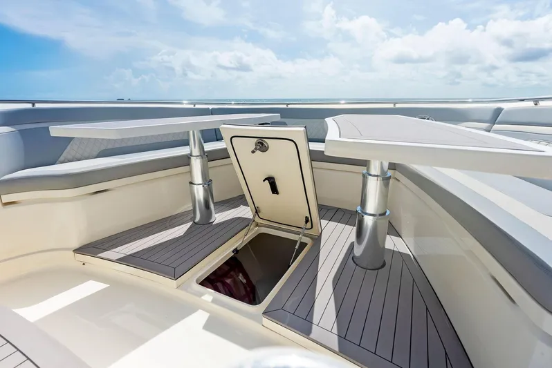 Bottom Line Yacht Photos Pics 2022 Scout LXF boat deck with open storage hatch and seating area.