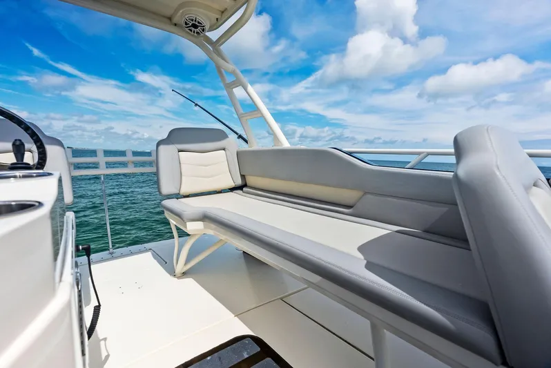 Bottom Line Yacht Photos Pics 2022 Scout LXF boat interior with cushioned seating, ocean view, and blue sky.