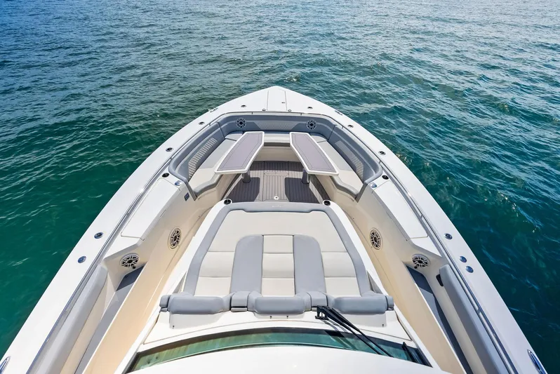 Bottom Line Yacht Photos Pics 2022 Scout LXF boat bow with seating, on calm blue water.