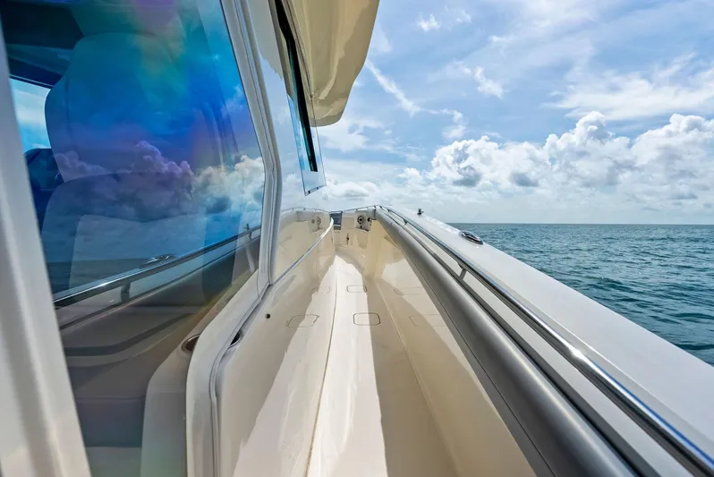 Bottom Line Yacht Photos Pics 2022 Scout LXF boat cruising on open sea under blue sky.