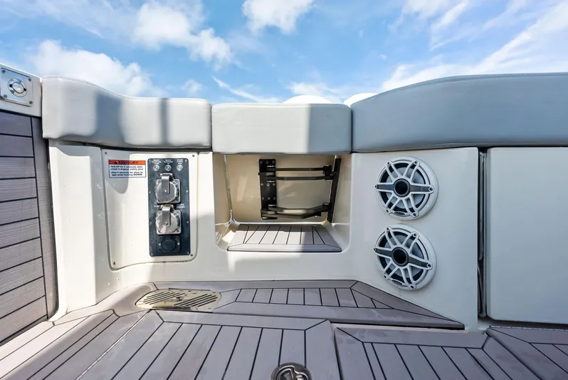 Bottom Line Yacht Photos Pics 2022 Scout LXF boat interior with speakers and storage compartment.
