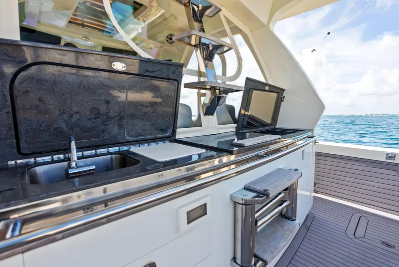 Bottom Line Yacht Photos Pics 2022 Scout LXF boat with sleek outdoor kitchen and ocean view.
