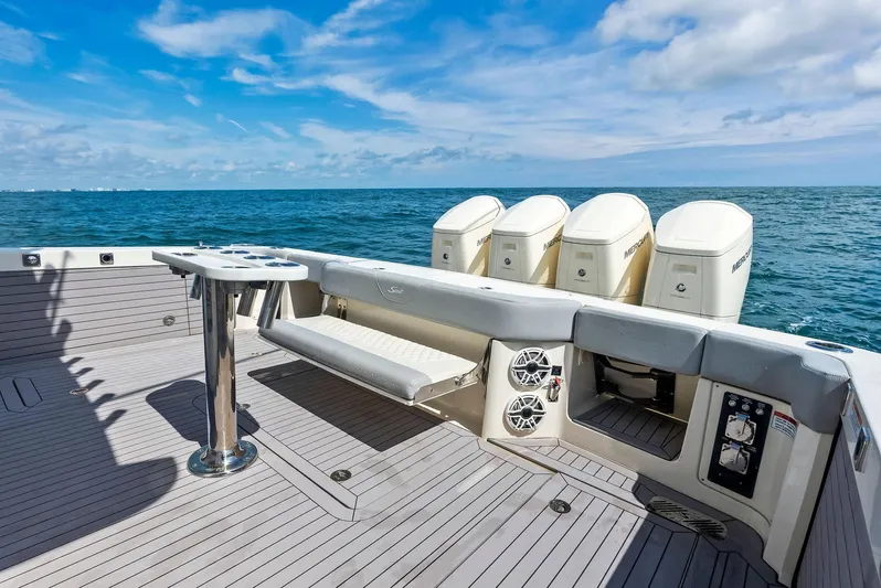 Bottom Line Yacht Photos Pics 2022 Scout LXF boat deck with quad engines on open sea.