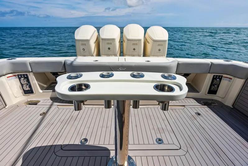 Bottom Line Yacht Photos Pics 2022 Scout LXF boat deck with fishing rod holders, ocean view.