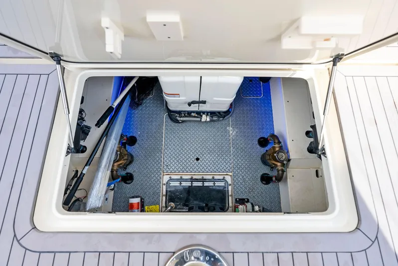 Bottom Line Yacht Photos Pics 2022 Scout LXF boat storage compartment with blue LED lighting.