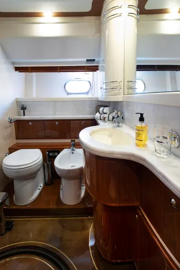  Yacht Photos Pics Luxurious bathroom in a 2003 Ferretti Yachts 760, featuring elegant wood finishes.