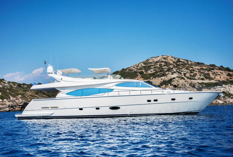  Yacht Photos Pics 2003 Ferretti Yachts 760 cruising on blue waters near rocky coastline.