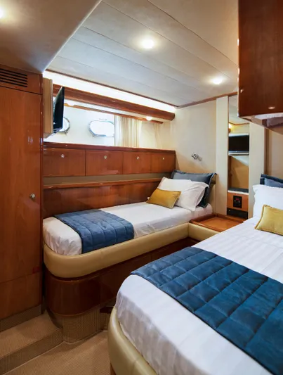  Yacht Photos Pics Luxurious cabin interior of 2003 Ferretti Yachts 760 with twin beds and elegant wood finish.