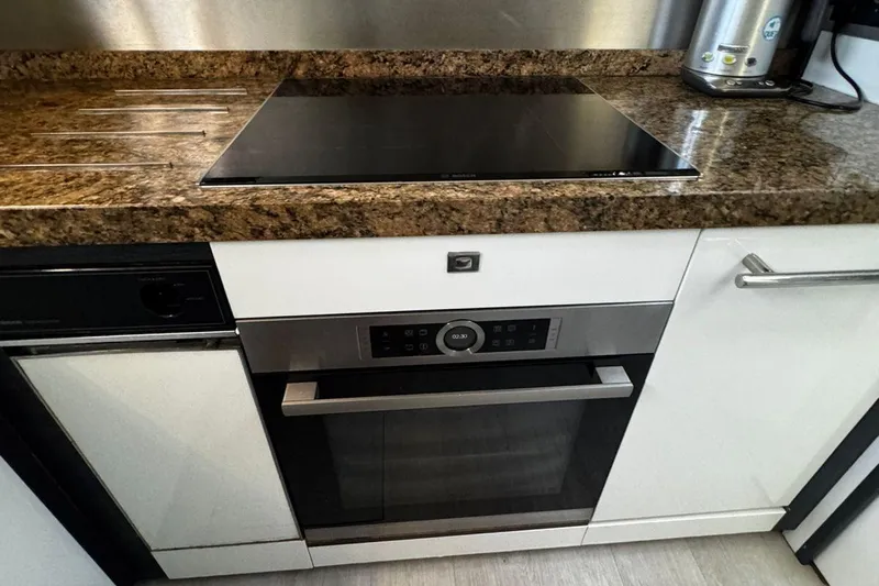  Yacht Photos Pics Modern kitchen with sleek oven and granite countertop, featuring Princess V85 model, 2008.