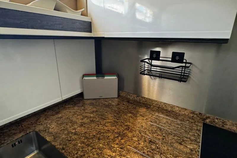  Yacht Photos Pics Modern kitchen countertop with storage rack in a 2008 Princess V85 yacht.