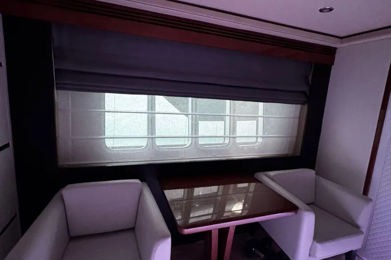  Yacht Photos Pics Interior of 2008 Princess V85 yacht with table and chairs by window.