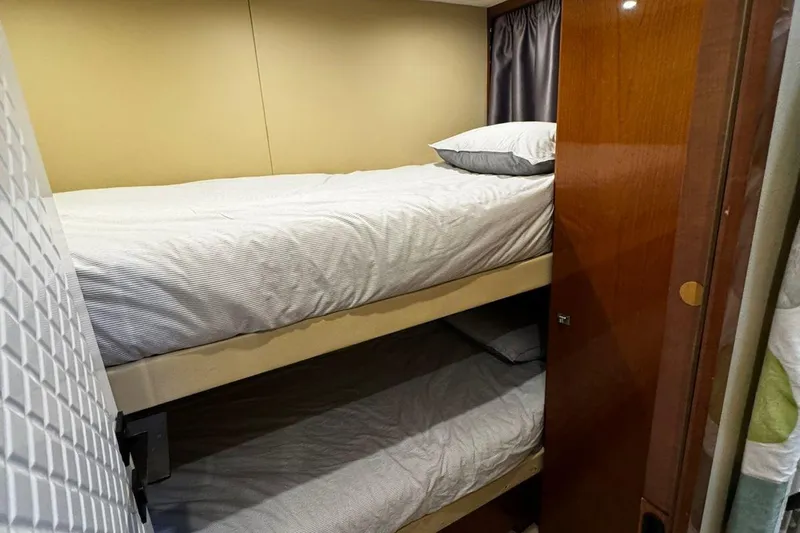  Yacht Photos Pics Bunk beds in 2008 Princess V85 yacht cabin with wooden accents and cozy bedding.