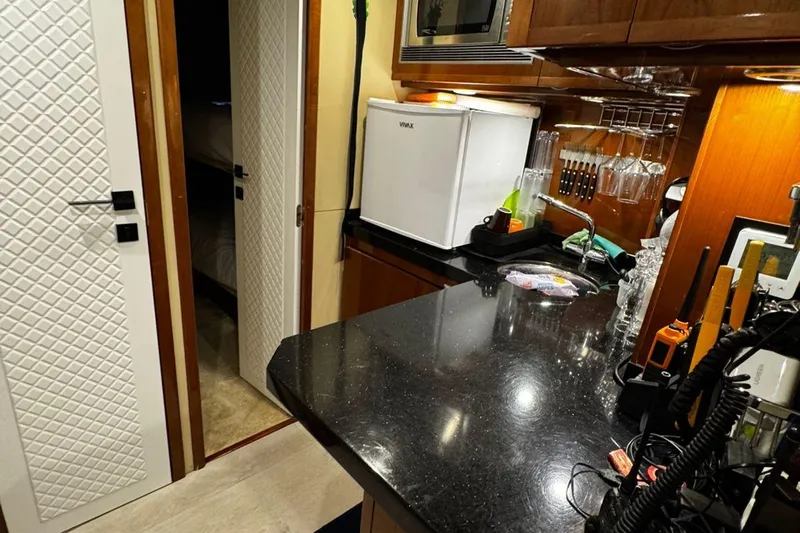  Yacht Photos Pics Luxurious 2008 Princess V85 yacht kitchen with modern appliances and sleek black countertop.