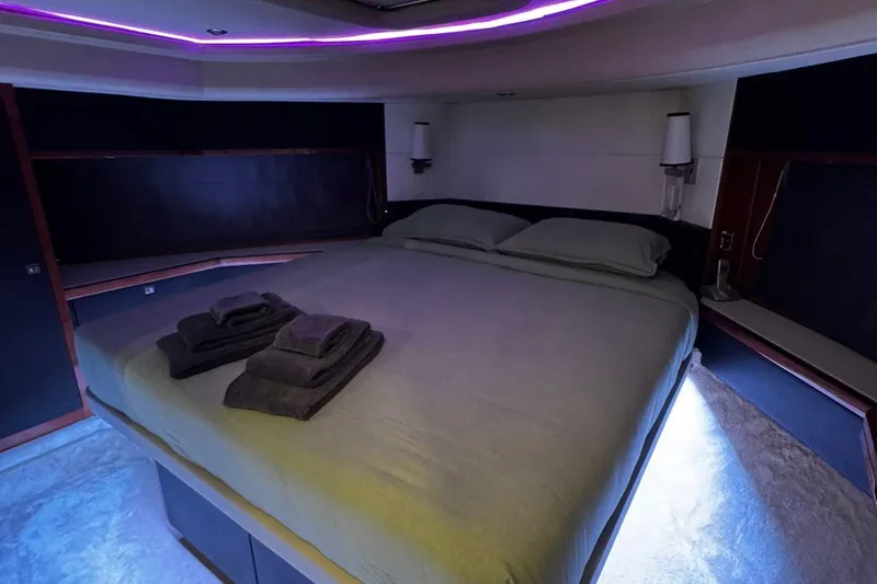  Yacht Photos Pics Luxurious bedroom interior of 2008 Princess V85 yacht with ambient lighting and neatly arranged towels.