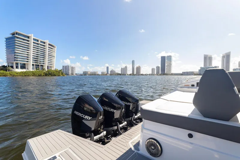  Yacht Photos Pics 2021 Cruisers Yachts 38 GLS with Mercury engines on a city waterfront.