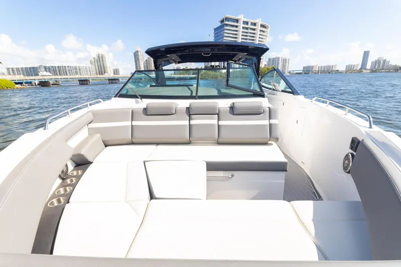  Yacht Photos Pics 2021 Cruisers Yachts 38 GLS boat with spacious seating, docked in a scenic urban waterfront.