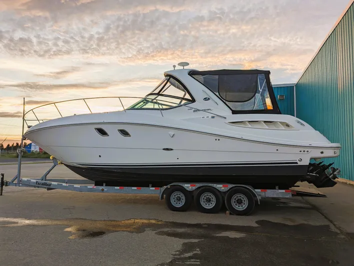  Yacht Photos Pics 2008 Sea Ray 330 Sundancer boat on trailer, parked outdoors at sunset.