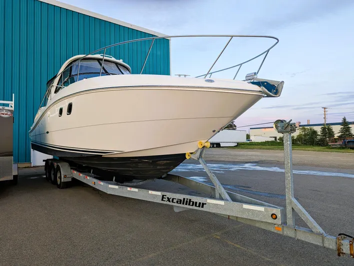  Yacht Photos Pics 2008 Sea Ray 330 Sundancer on Excalibur trailer near blue building.