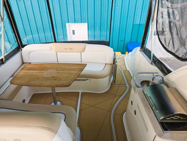  Yacht Photos Pics 2008 Sea Ray 330 Sundancer interior with white seating, wooden table, and kitchenette.