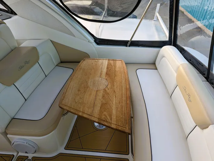  Yacht Photos Pics 2008 Sea Ray 330 Sundancer interior with wooden table and cushioned seating.