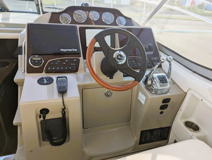  Yacht Photos Pics 2008 Sea Ray 330 Sundancer helm with Raymarine electronics and wood-accented steering wheel.