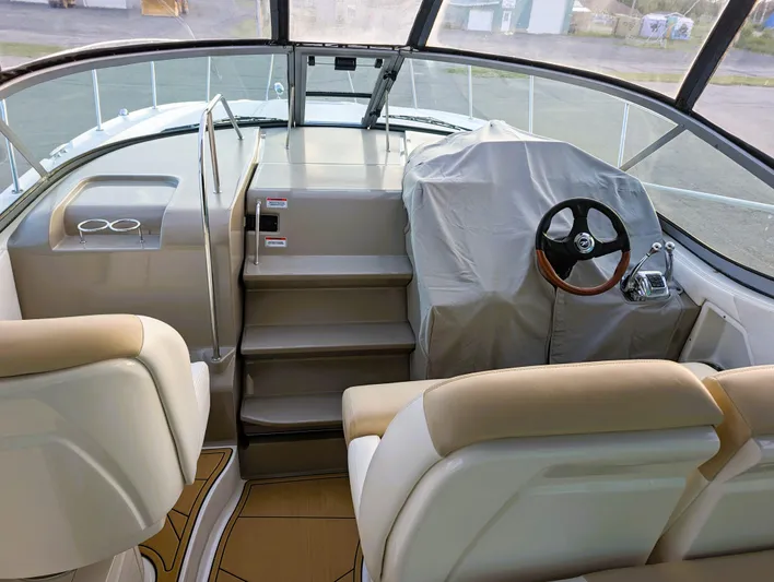 Yacht Photos Pics 2008 Sea Ray 330 Sundancer cockpit with covered helm and beige seating.