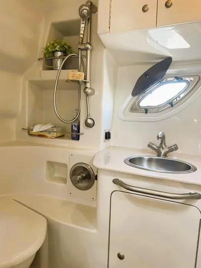  Yacht Photos Pics 2008 Sea Ray 330 Sundancer bathroom with sink, shower, and porthole window.