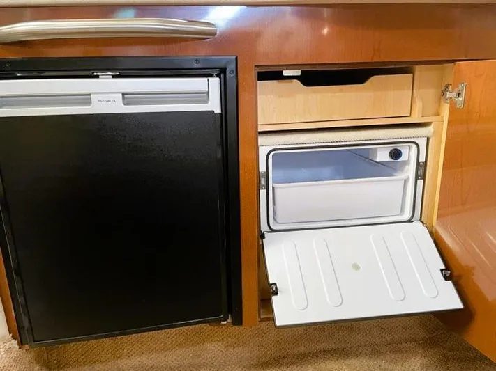  Yacht Photos Pics 2008 Sea Ray 330 Sundancer interior with open fridge and freezer compartments.