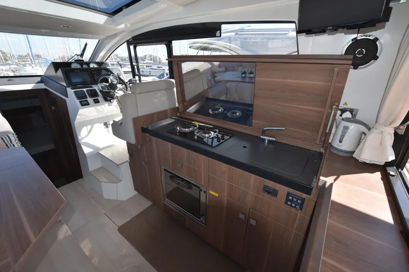 Indian Summer Yacht Photos Pics Interior of 2016 Sealine C330 yacht with modern kitchen and helm station.