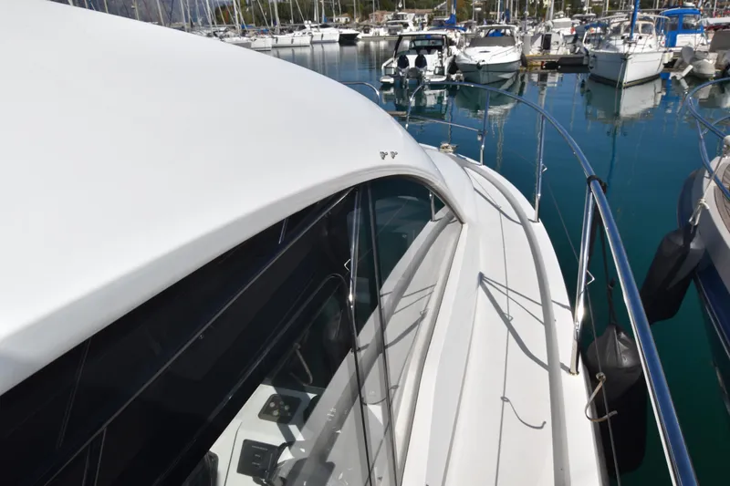 Indian Summer Yacht Photos Pics 2016 Sealine C330 yacht docked in a marina, showcasing sleek design and modern features.