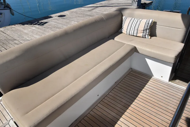 Indian Summer Yacht Photos Pics 2016 Sealine C330 yacht with beige seating and striped cushion on deck.