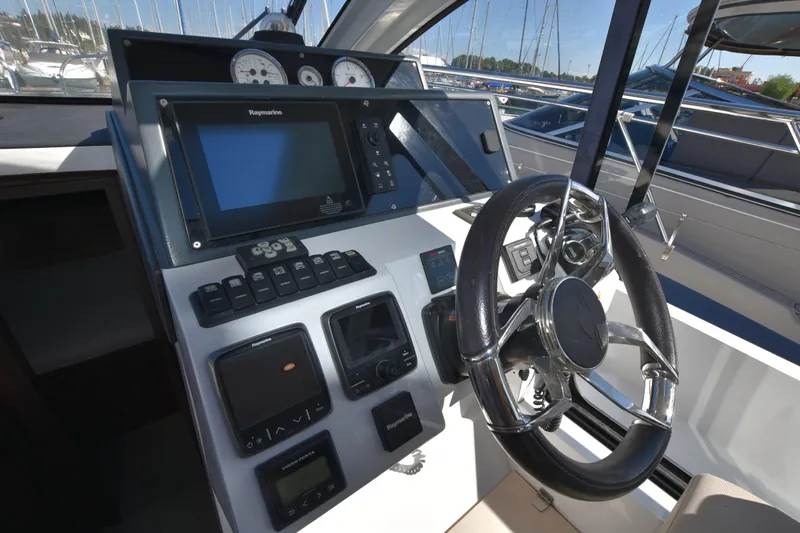 Indian Summer Yacht Photos Pics Sealine C330 2016 helm with navigation controls and steering wheel.