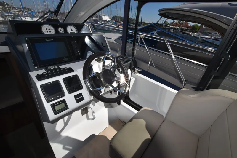 Indian Summer Yacht Photos Pics 2016 Sealine C330 yacht cockpit with modern navigation controls and steering wheel.